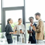 Four multiethnic colleagues holding disposable cup 2026 01 06 00 37 42 utc - Hvordan bygge gode relasjoner i arbeidslivet