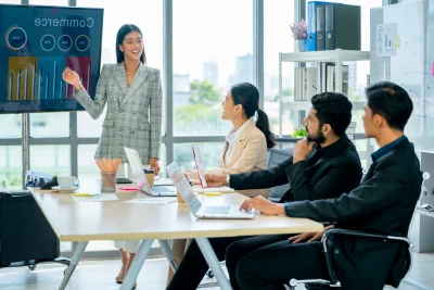 Pretty asian business woman stand to present the p 2026 01 08 22 23 33 utc - Kost-nytte-analyse for konsulentbruk: mal + eksempler (NPV, sce...